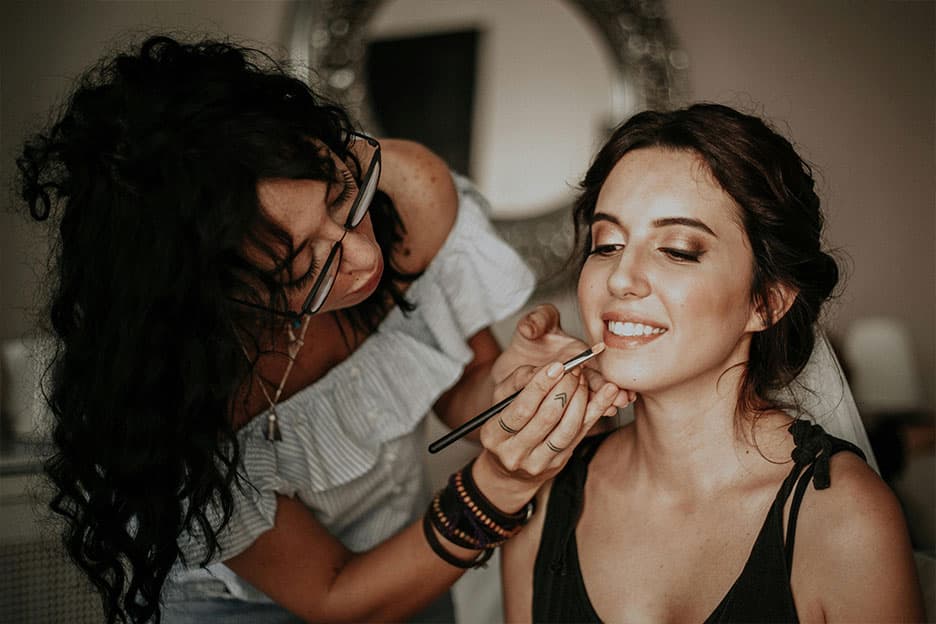 Bridal having her makeup done by a professional artist